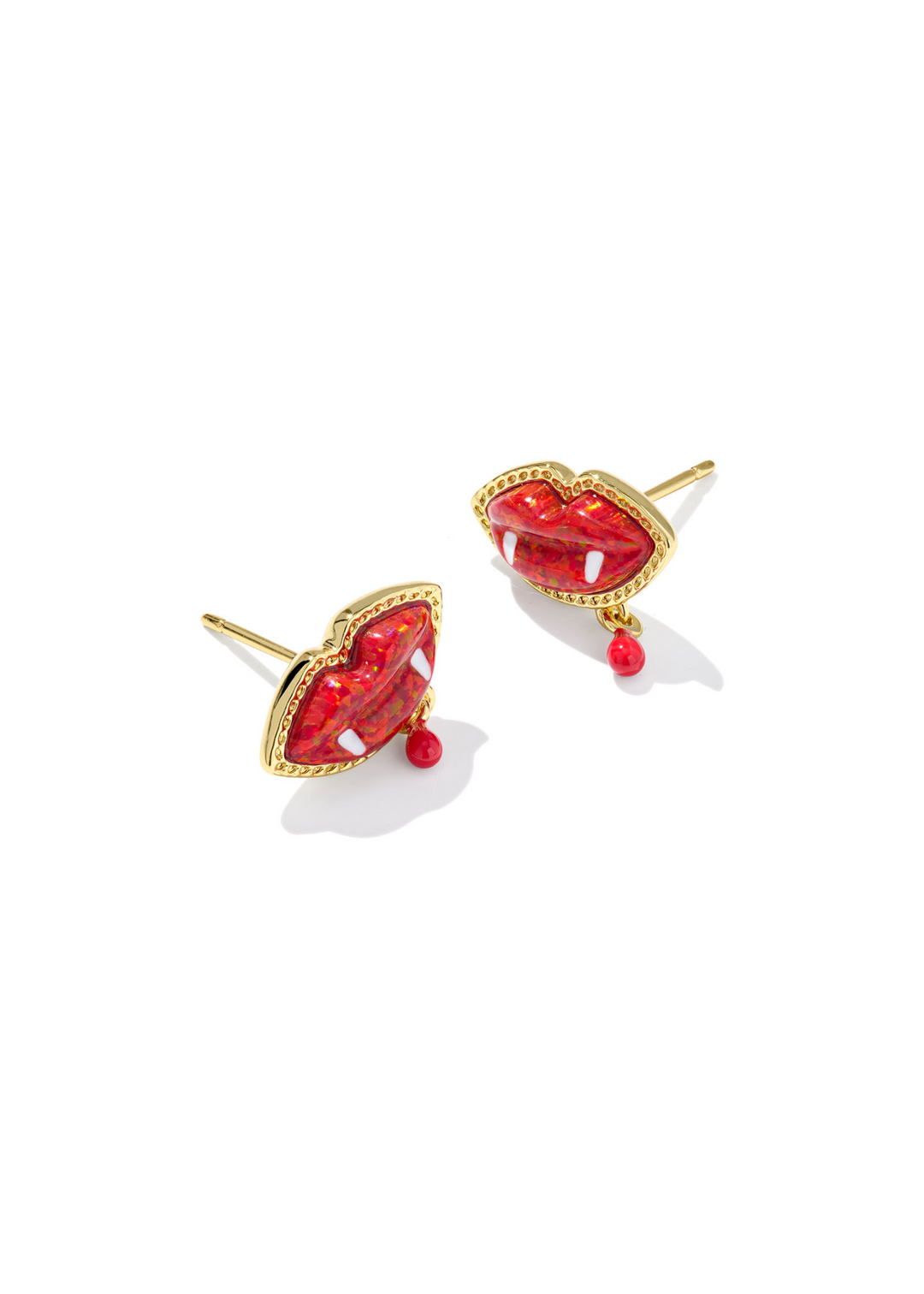 Gold framed stud earrings with red vampire lips shaped center stone on a white background