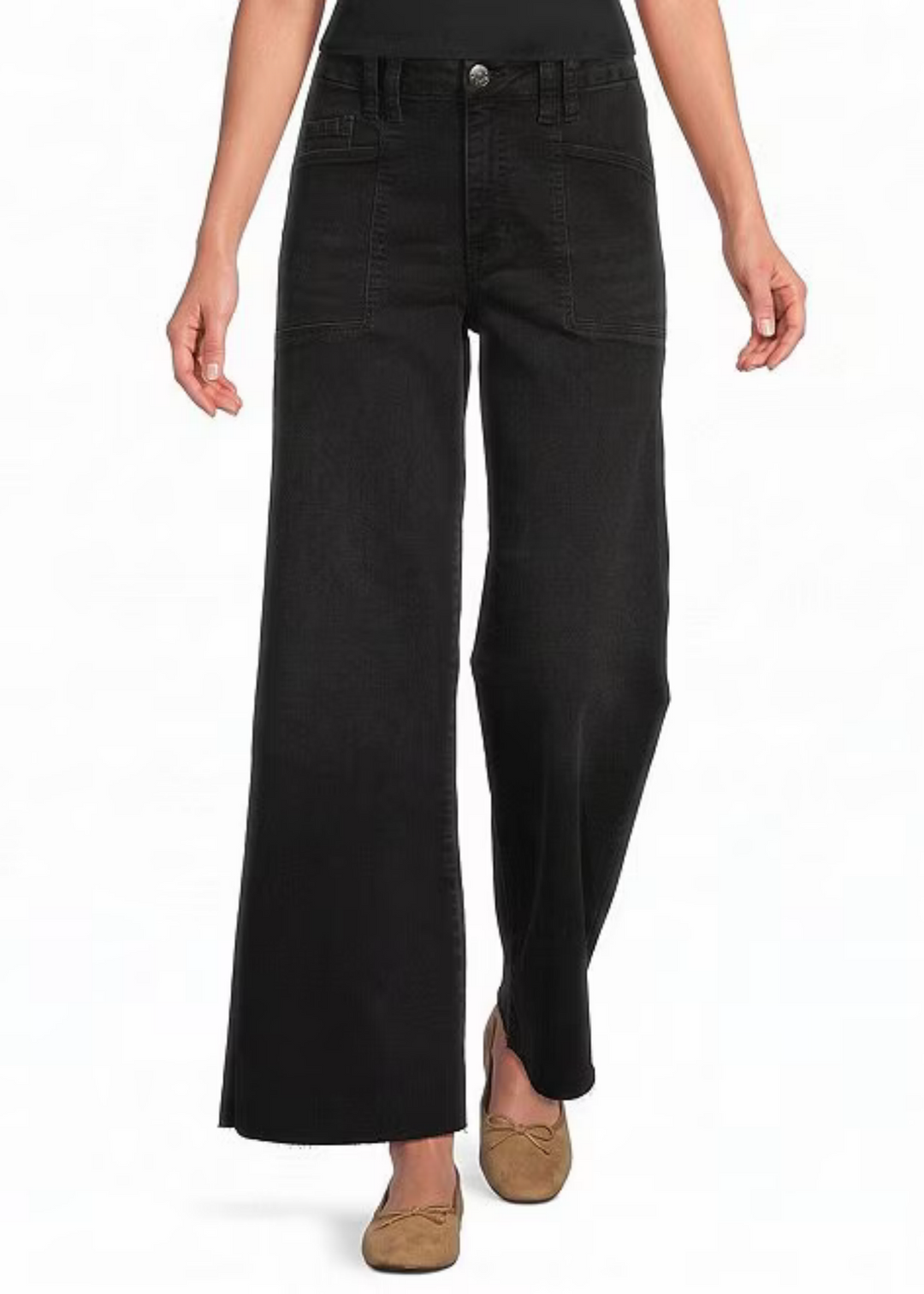A model wearing a pair of wide-leg black jeans with a button fly and brown flat shoes, shown from the waist down on a white background.