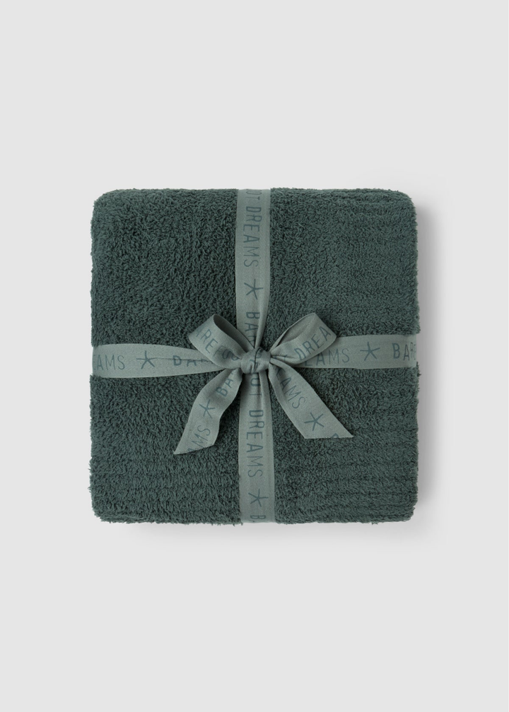 A folded dark green terry cloth towel wrapped with a matching gray ribbon and bow, set against a light gray background.