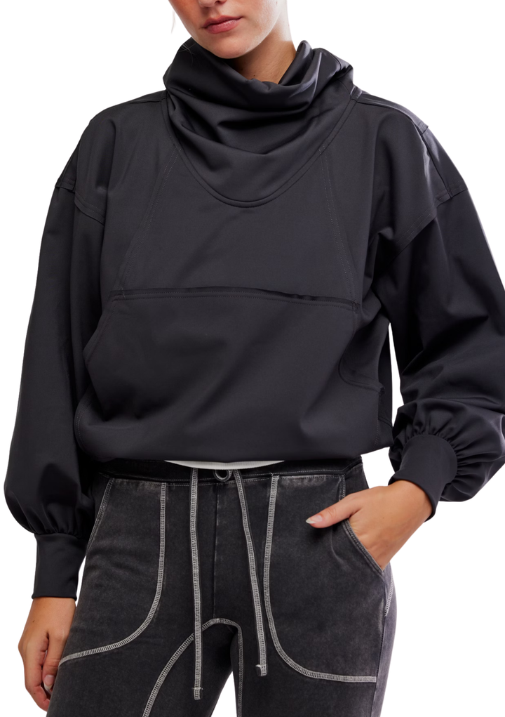 Person wearing a black oversized sweater with a high collar on a white background