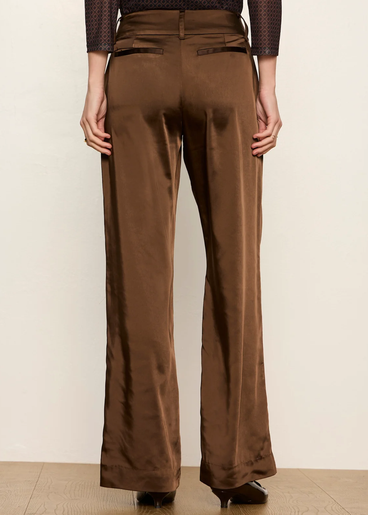 Woman wearing brown dress pant and kitten heel.