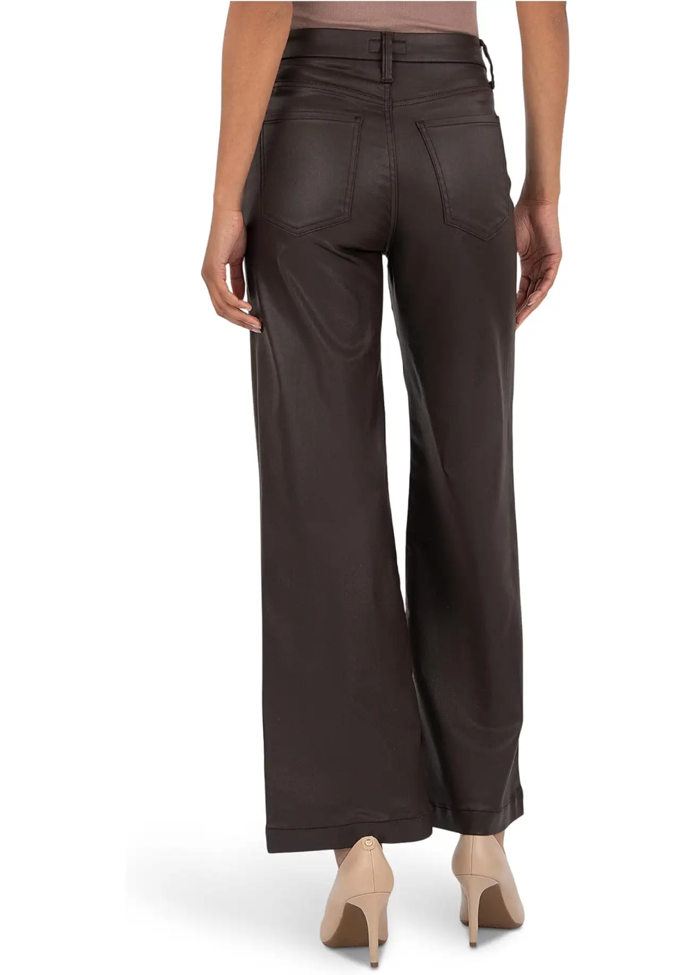 Woman wearing chocolate colored wide leg jeans and turned around.
