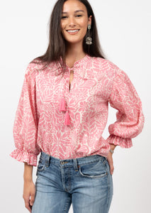 pink and off white leaf floral print top with dramatic balloon puff sleeves and a split neck with ties and tassels 