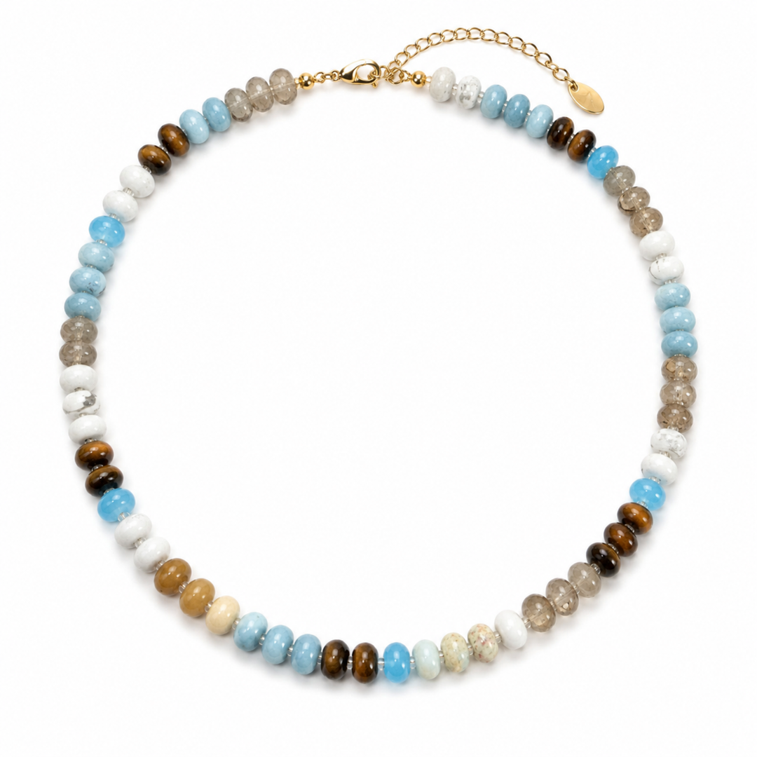 A beaded choker necklace featuring a mix of light blue, brown, white, beige, and gray gemstone beads, accented by a gold chain extender and clasp, shown on a plain white background.