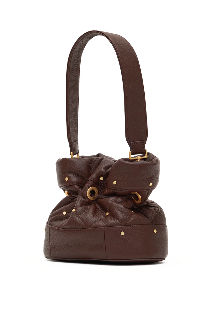 A dark brown leather bucket bag with a gathered bow detail, gold-tone studs, and a matching shoulder strap, shown against a plain white background.