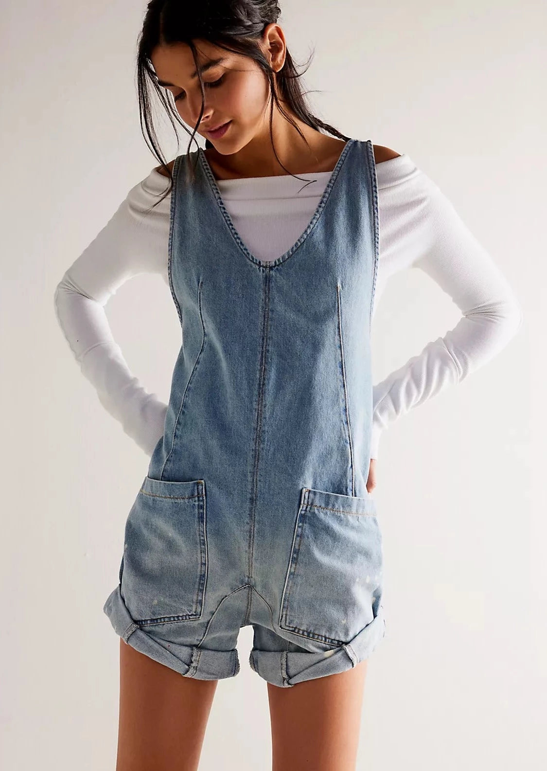light/medium wash denim romper with cuffed shorts and front pockets