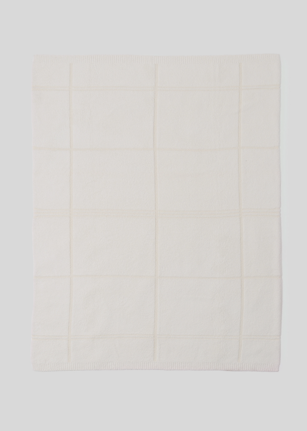 Cream colored plaid black layed out on a white background
