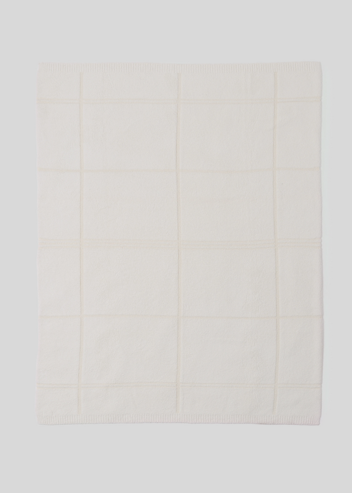 Cream colored plaid black layed out on a white background