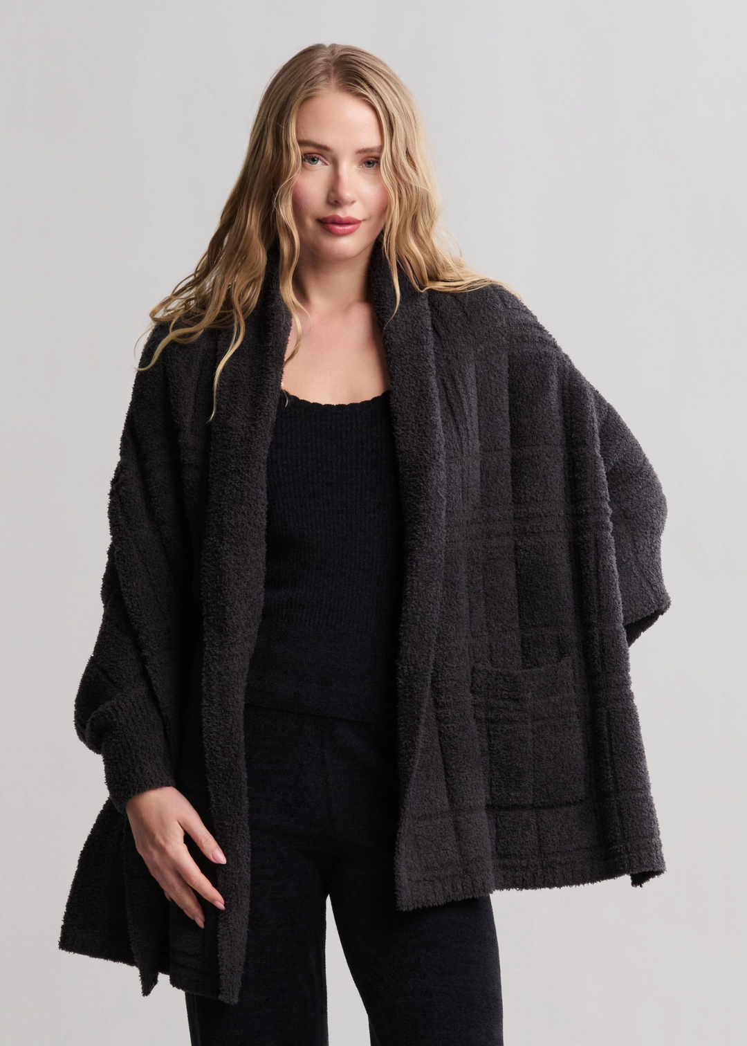 Woman wearing a charcoal grey fuzzy wrap