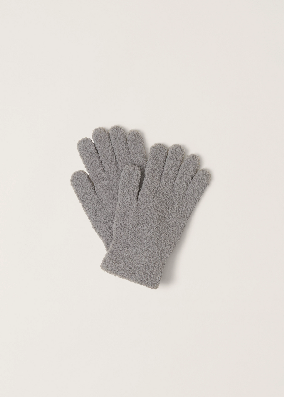 Women's grey fuzzy gloves on a white background