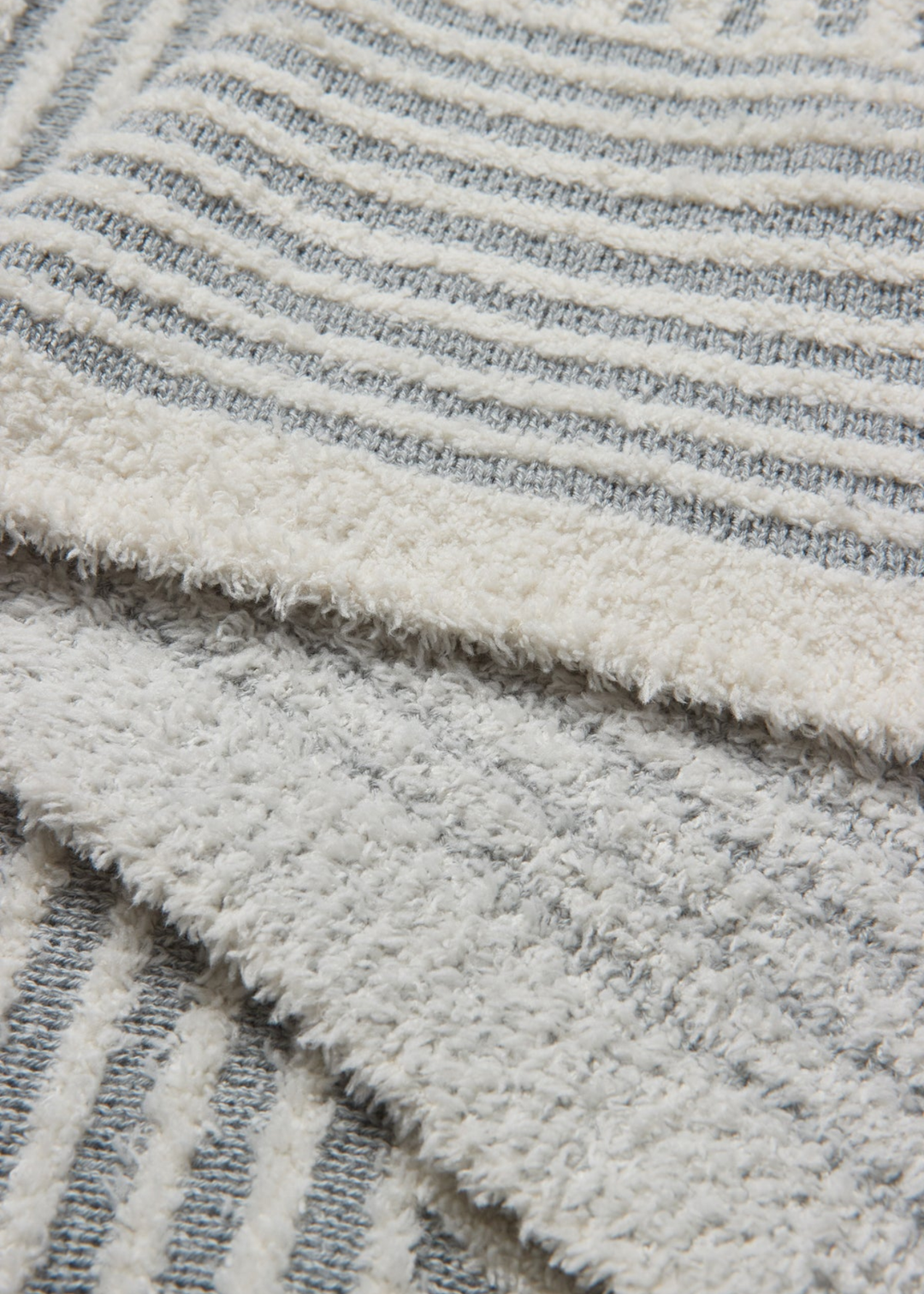 Close up of a grey and white stripe blanket