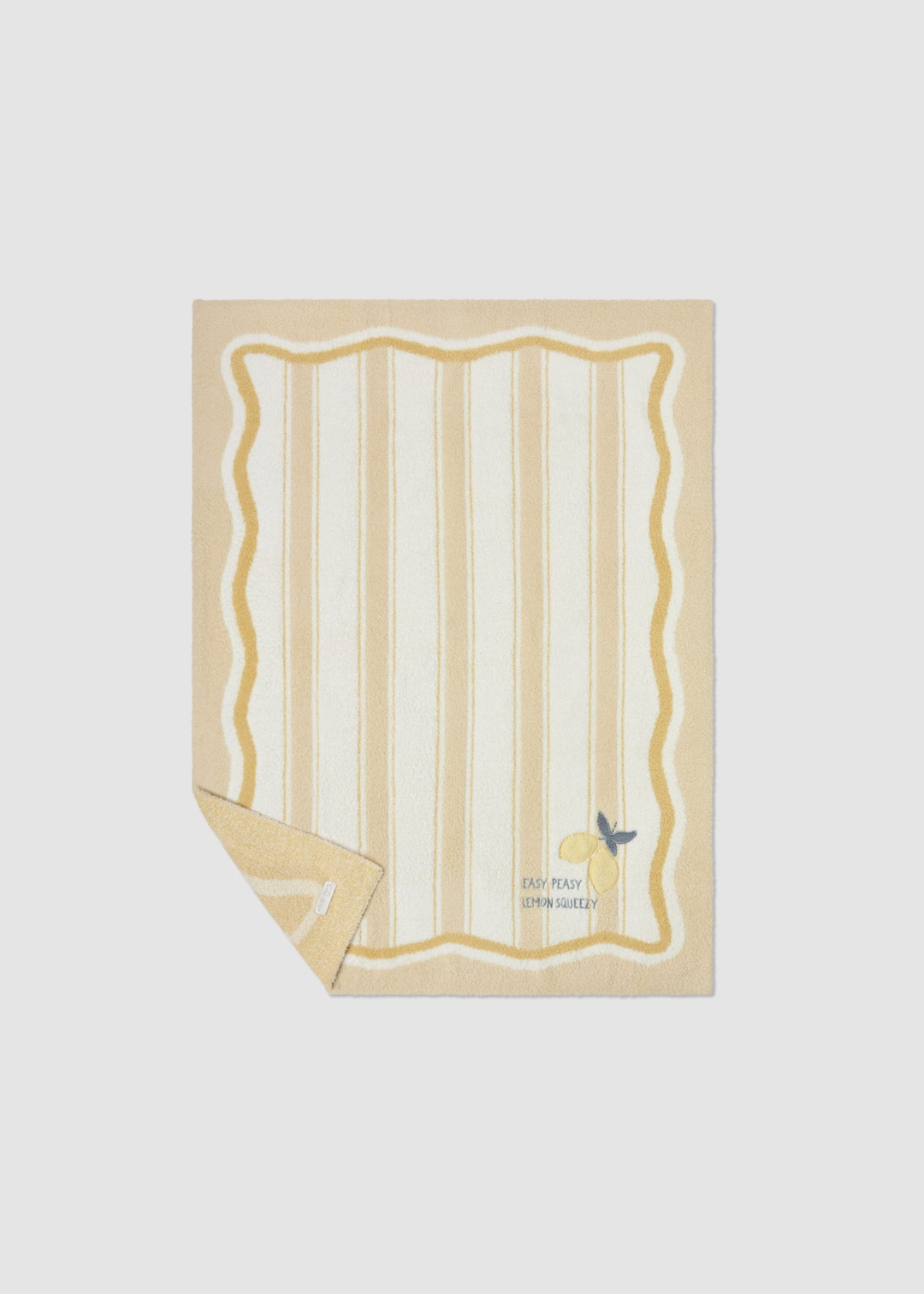 Yellow baby blanket with a striped pattern and lemon embroidery and lettering with a corned folded