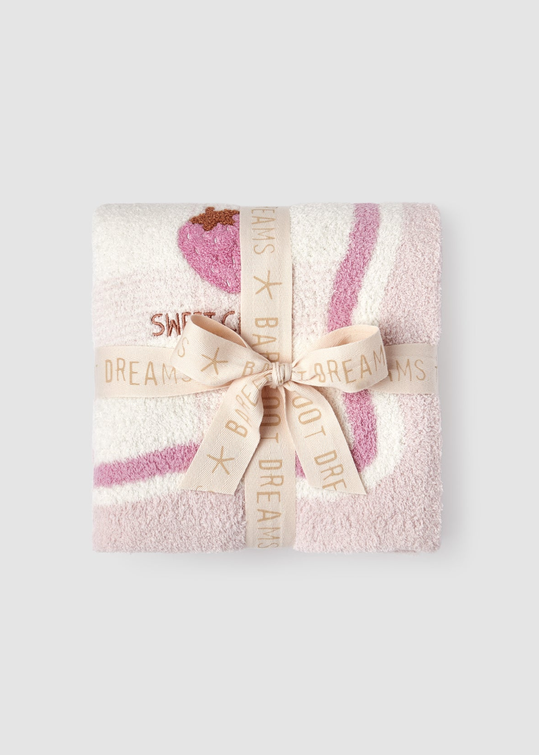 Pink baby blanket with a strawberry graphic folded and tied with a light pink ribbon