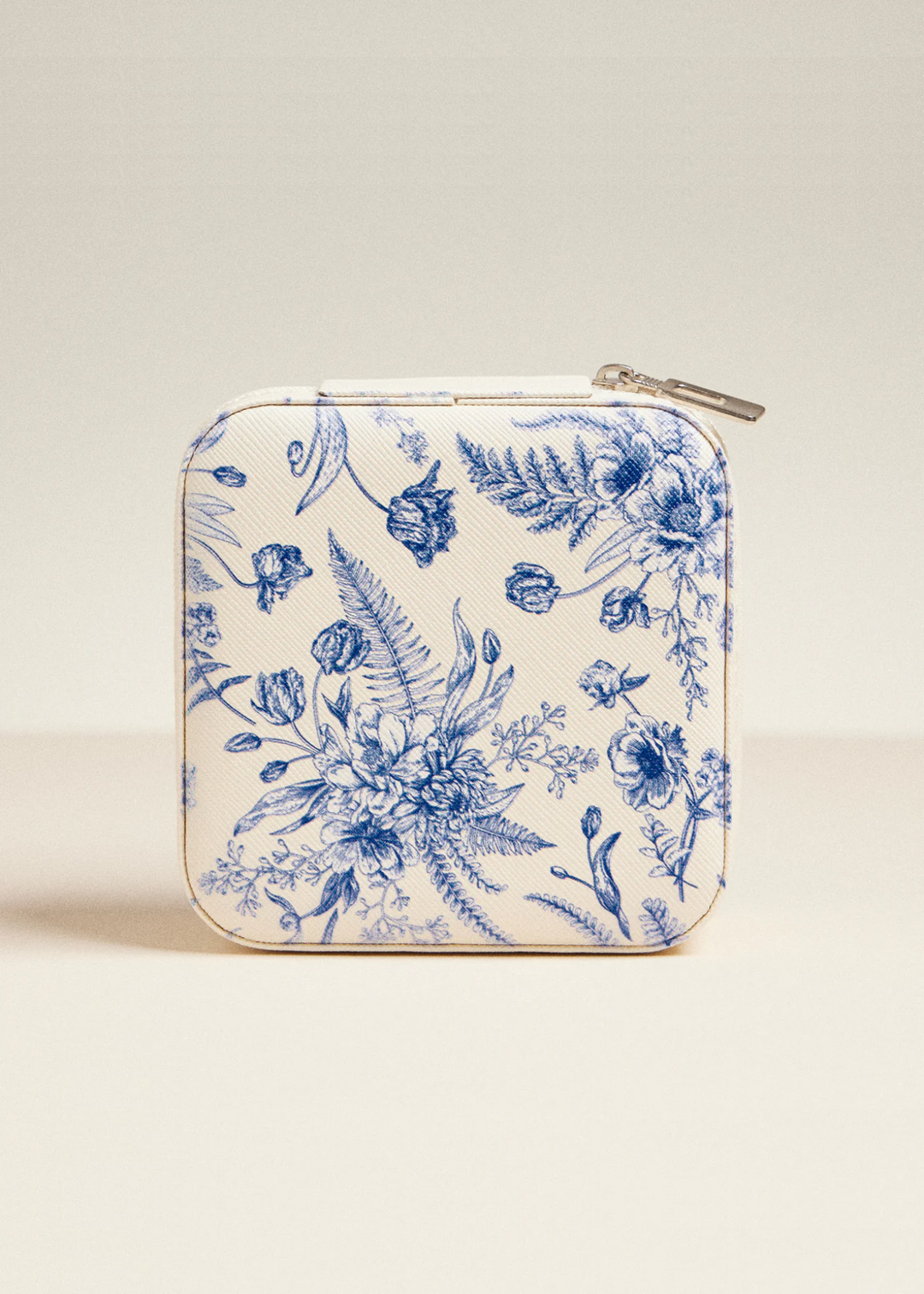 White travel jewelry box with a navy floral print on a white background