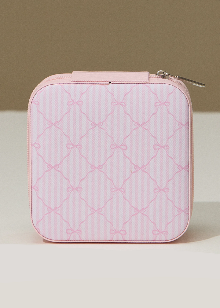 Pink striped travel jewelry box with a pink bow pattern