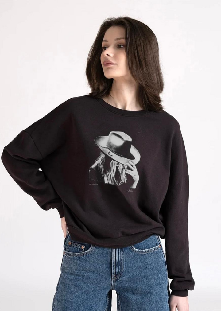 black crew neck sweatshirt with woman wearing hat graphic on chest