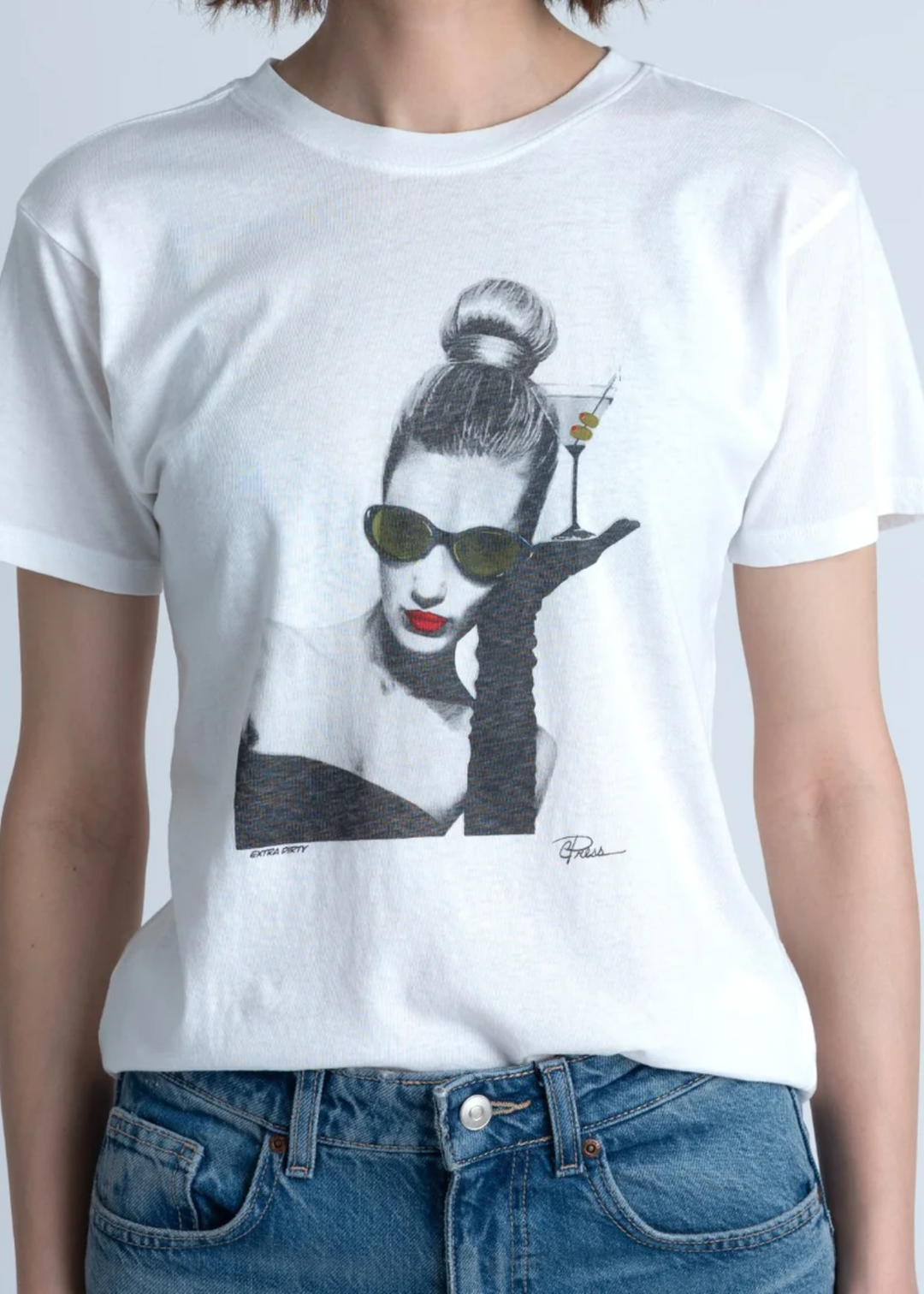 Woman wearing a white t-shirt with a woman holding a martini graphic