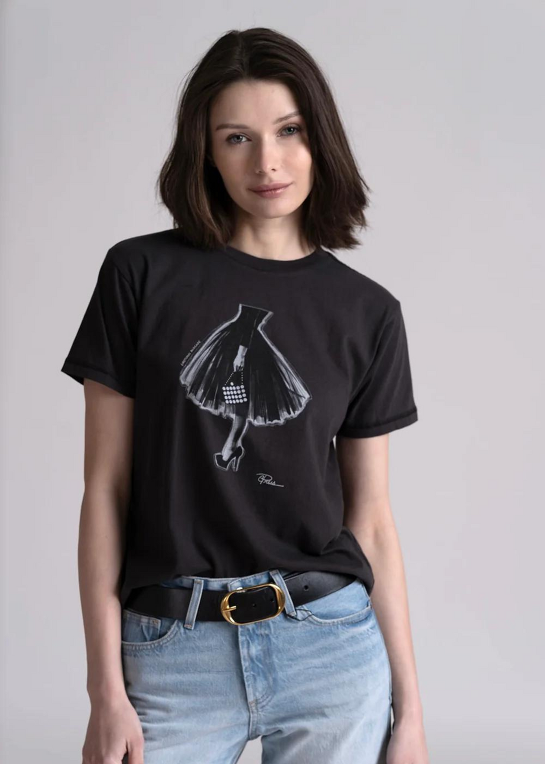 black short sleeve tee with graphic of bottom half of woman wearing elegant tulle skirt  with stilettos holding a white purse