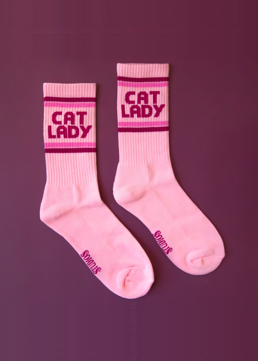 Pink crew socks with "Cat Lady" graphic and stripes