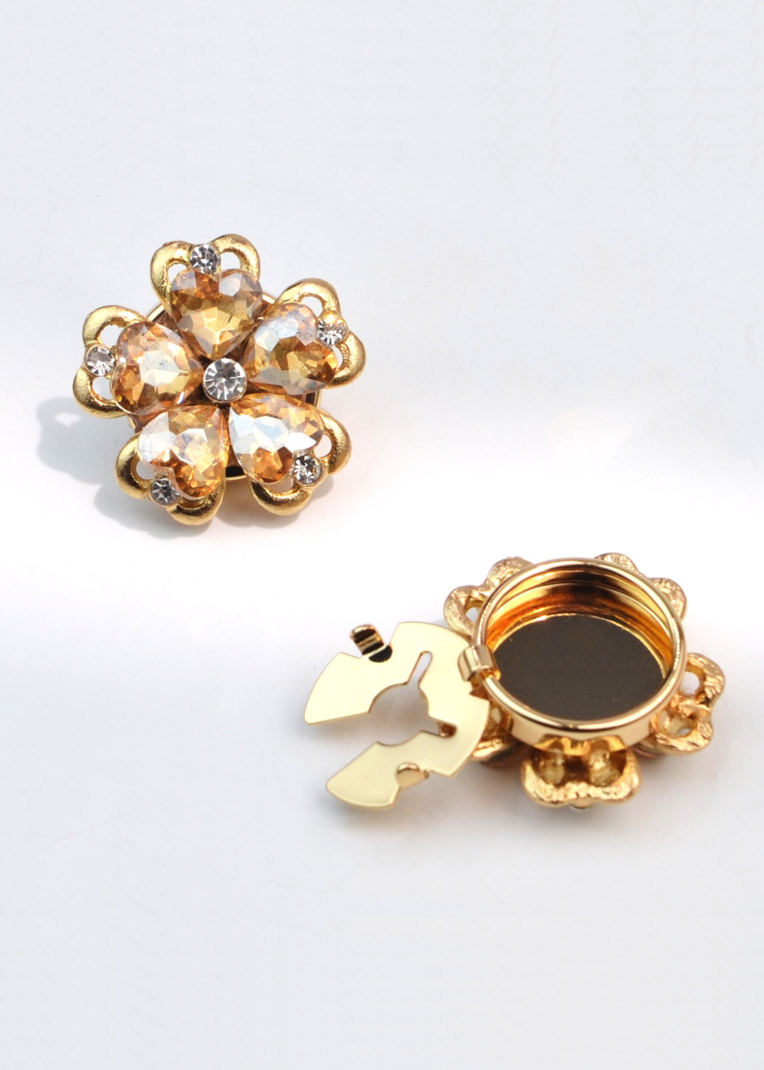 Champagne and gold flower shaped button cover on a white background