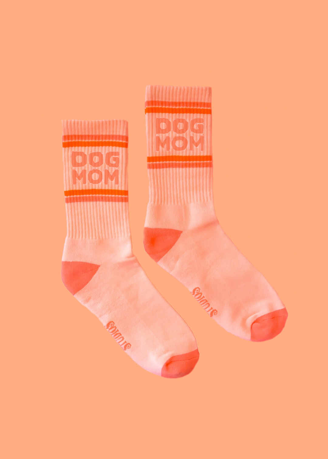 Pink ribbed crew socks with orange stripes and "Dog Mom" lettering