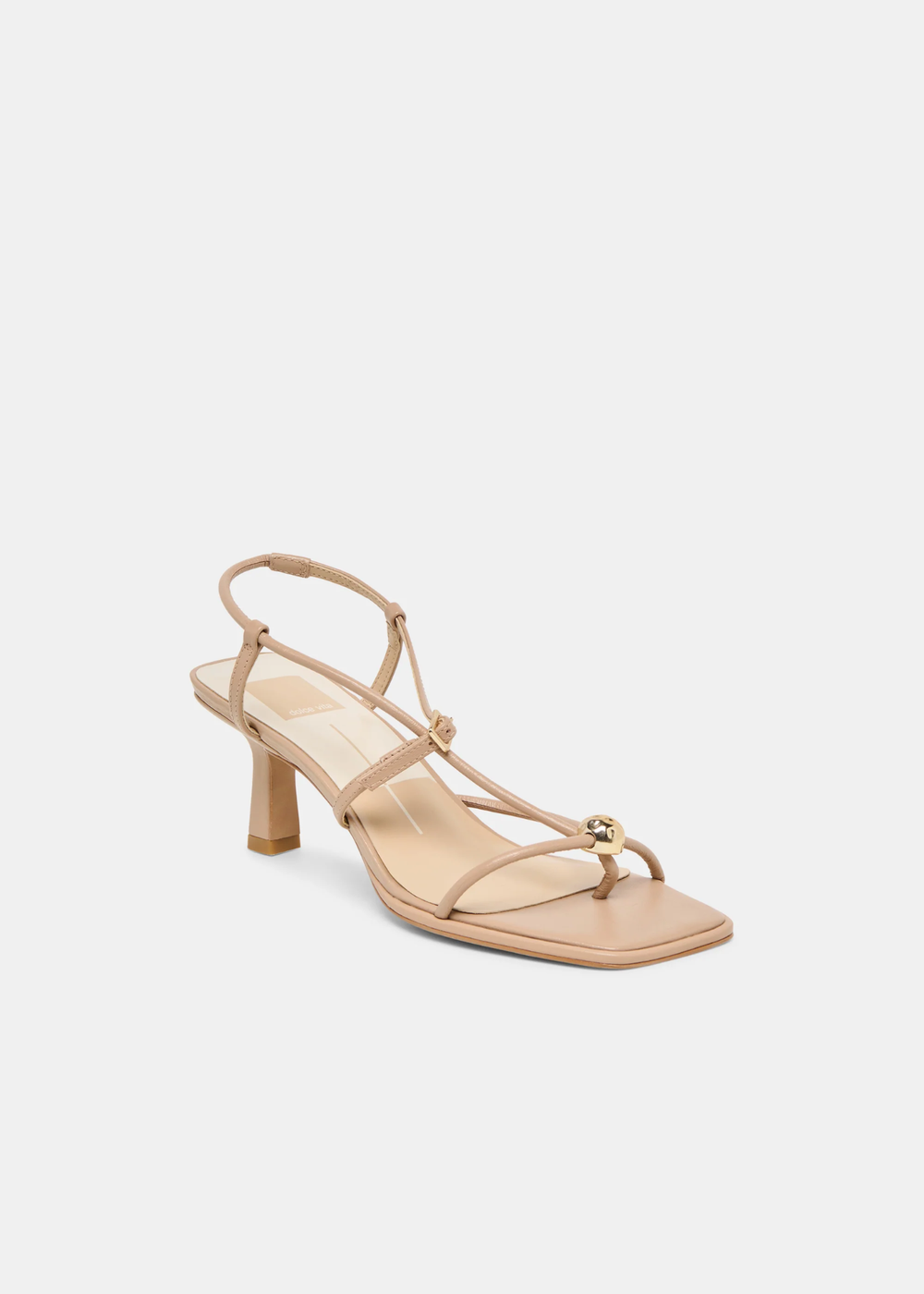 Side view of tan strappy heels with a gold button against a white background