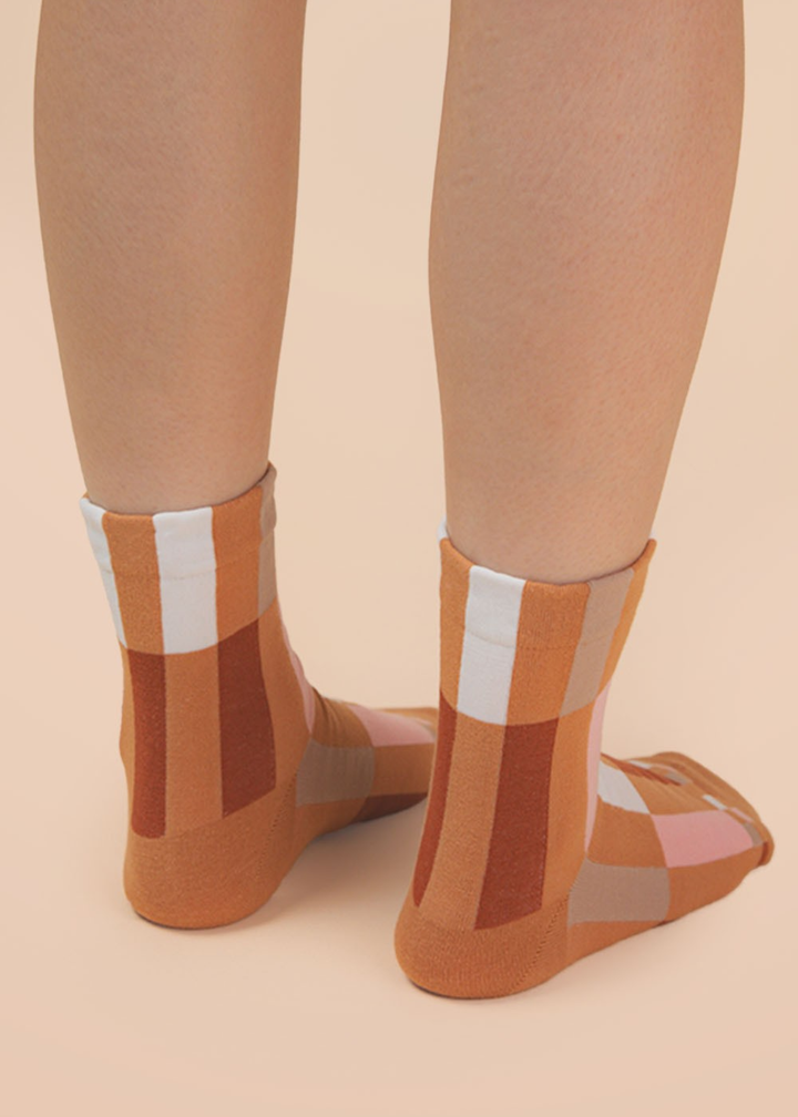 Person wearing brown colorblock socks