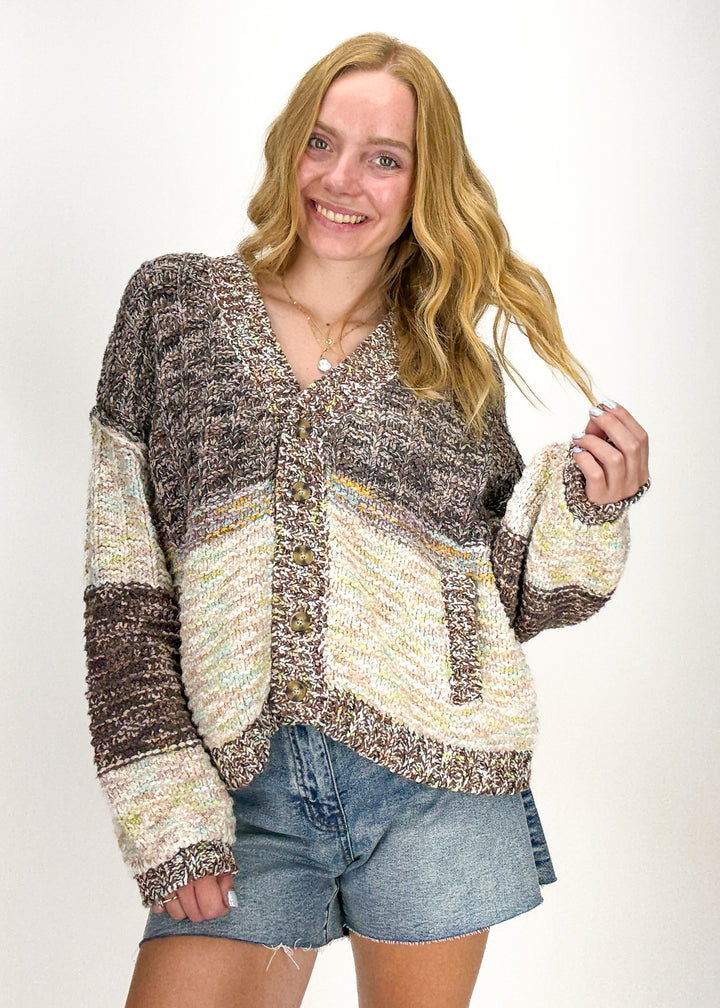 woman wearing Free People cream and brown speck oversized cardigan