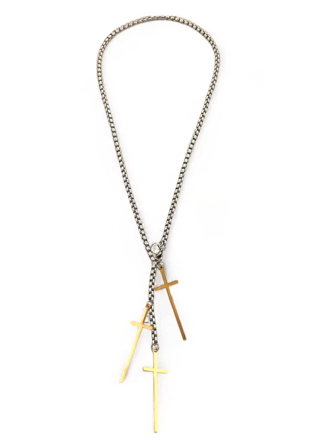 Silver chain necklace with three gold cross charms on a white background