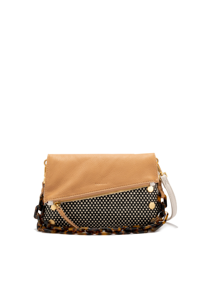 White, tan, and black handbag with gold accents against a white background