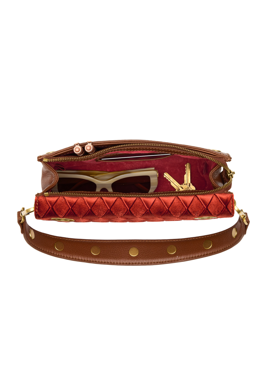 Red velvet and brown leather purse open on a white background