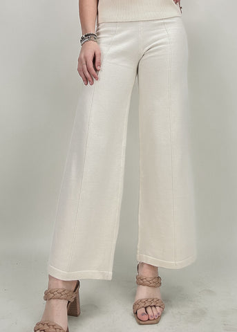 cream wide leg pants with front seam and patching top