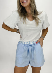 blue cloth drawstring shorts with blue and white stripe waistband and pockets