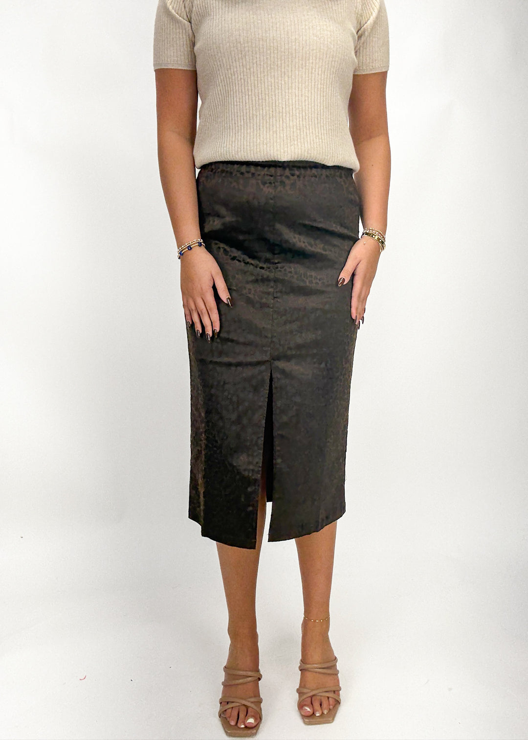 Person wearing a dark gray skirt on a white background