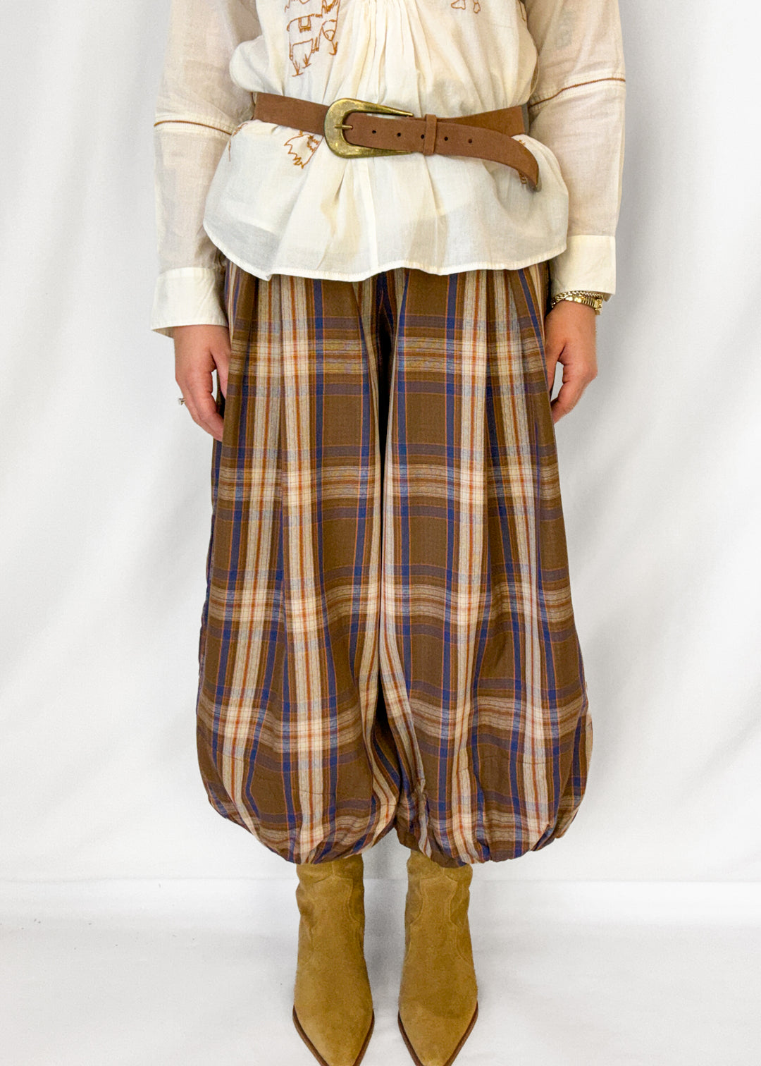 Woman wearing brown plaid balloon style pants