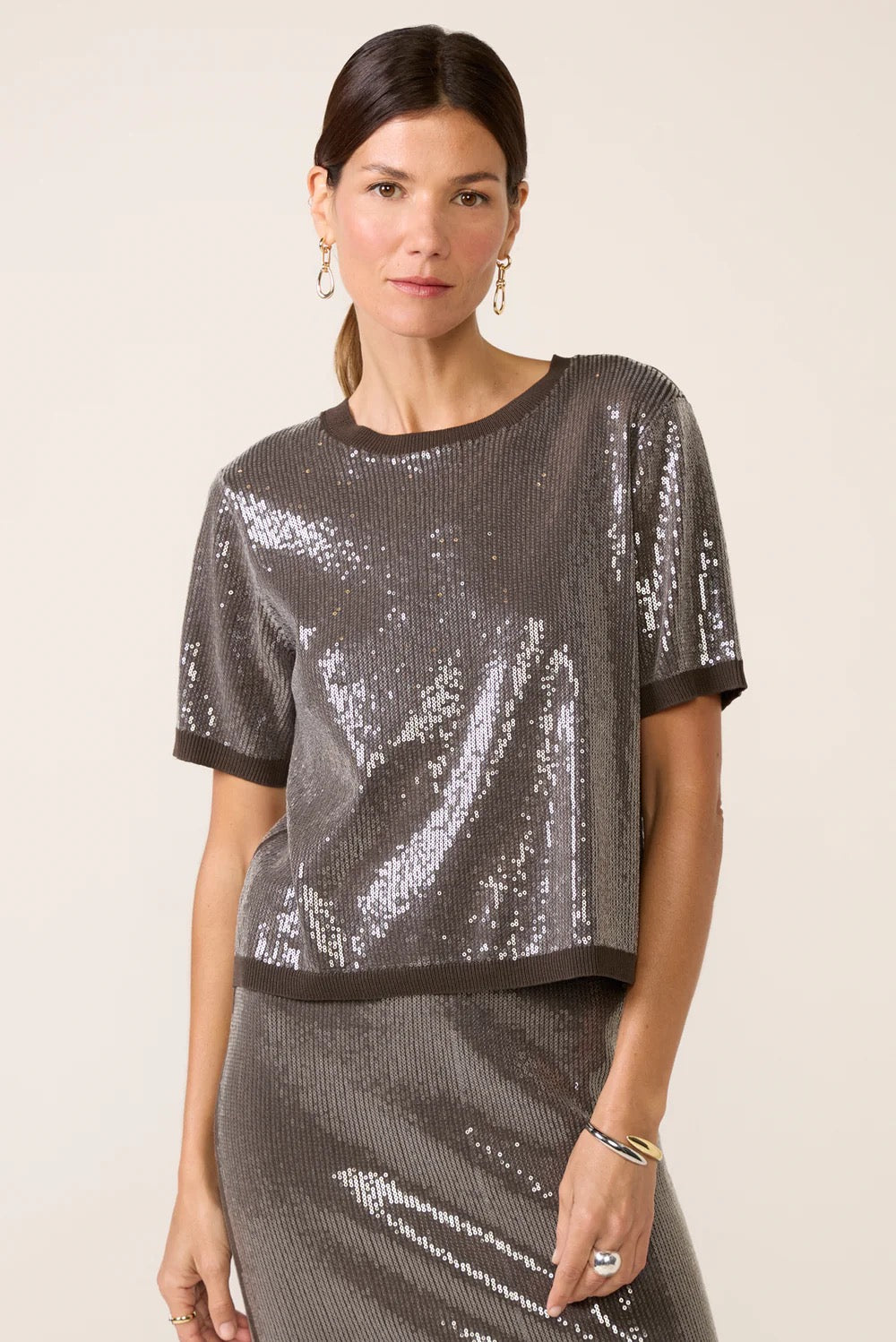Woman wearing a sequined top and skirt 