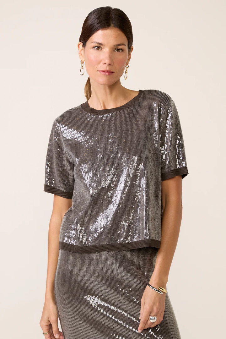 Woman wearing a sequined top and skirt 