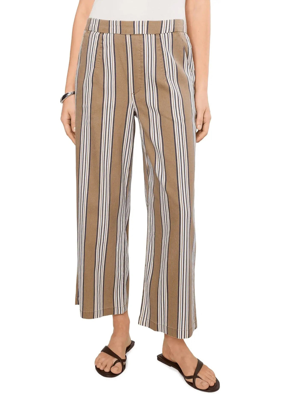 Person wearing brown, navy, white striped pants on a white background