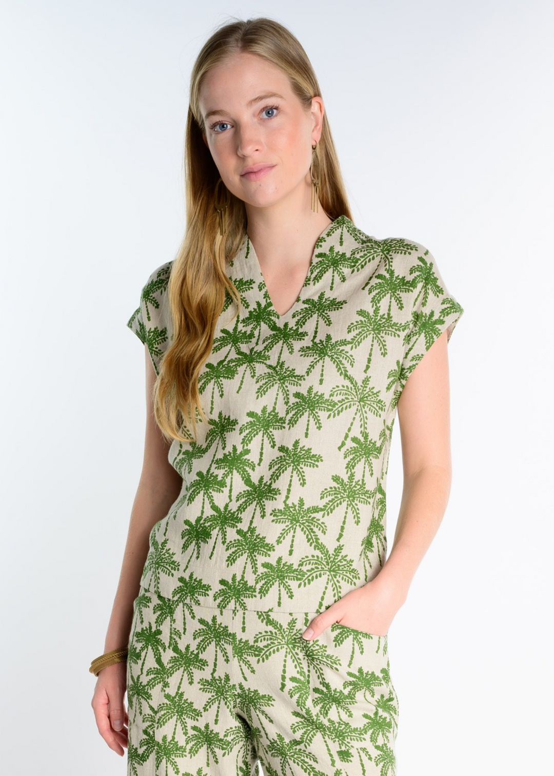 tan and green women's split neck palm tree print top