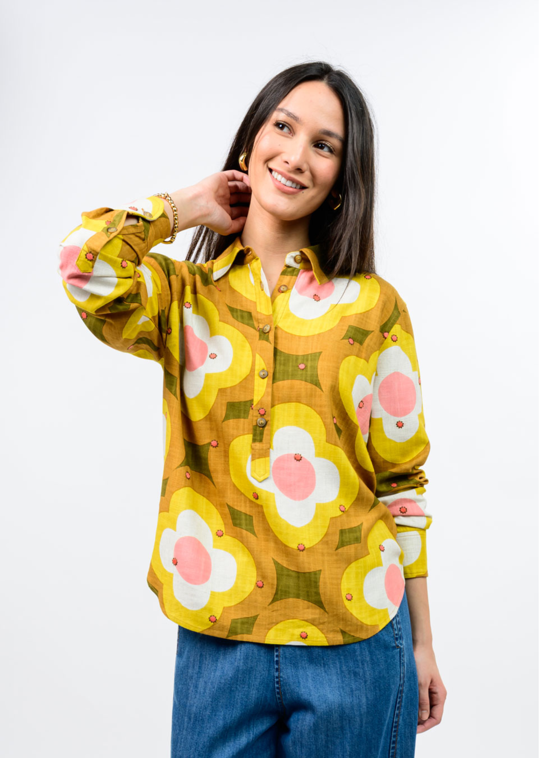 Woman in a multi colored, half button down floral top. 