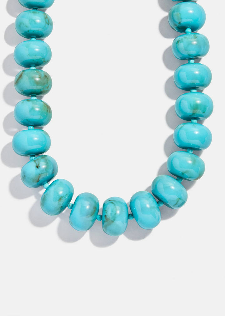 Turquoise beaded necklace on a white background