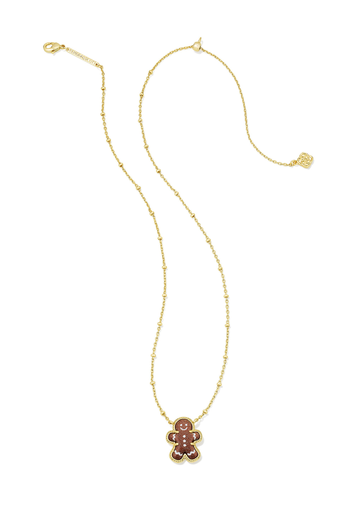Gold necklace with a brown sparkly gingerbread pendant on a white background