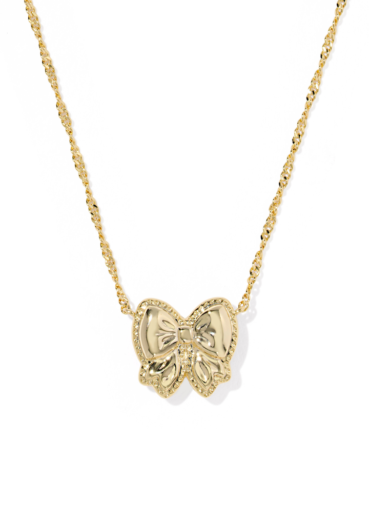 Gold necklace with a gold bow pendant on a white background
