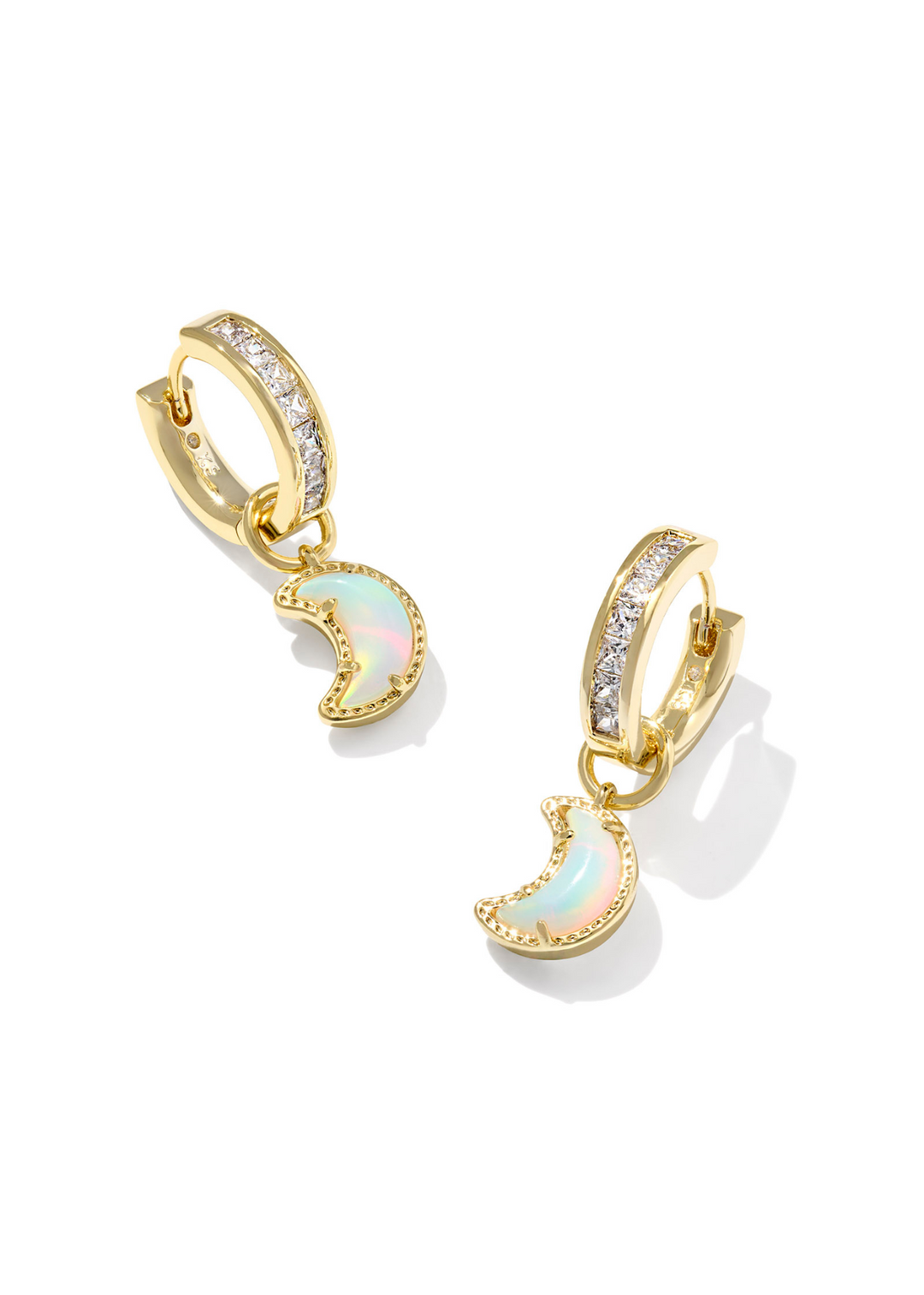 Gold huggie earrings with CZ studding and a moon shape with a white/iridescent center stone on a white background