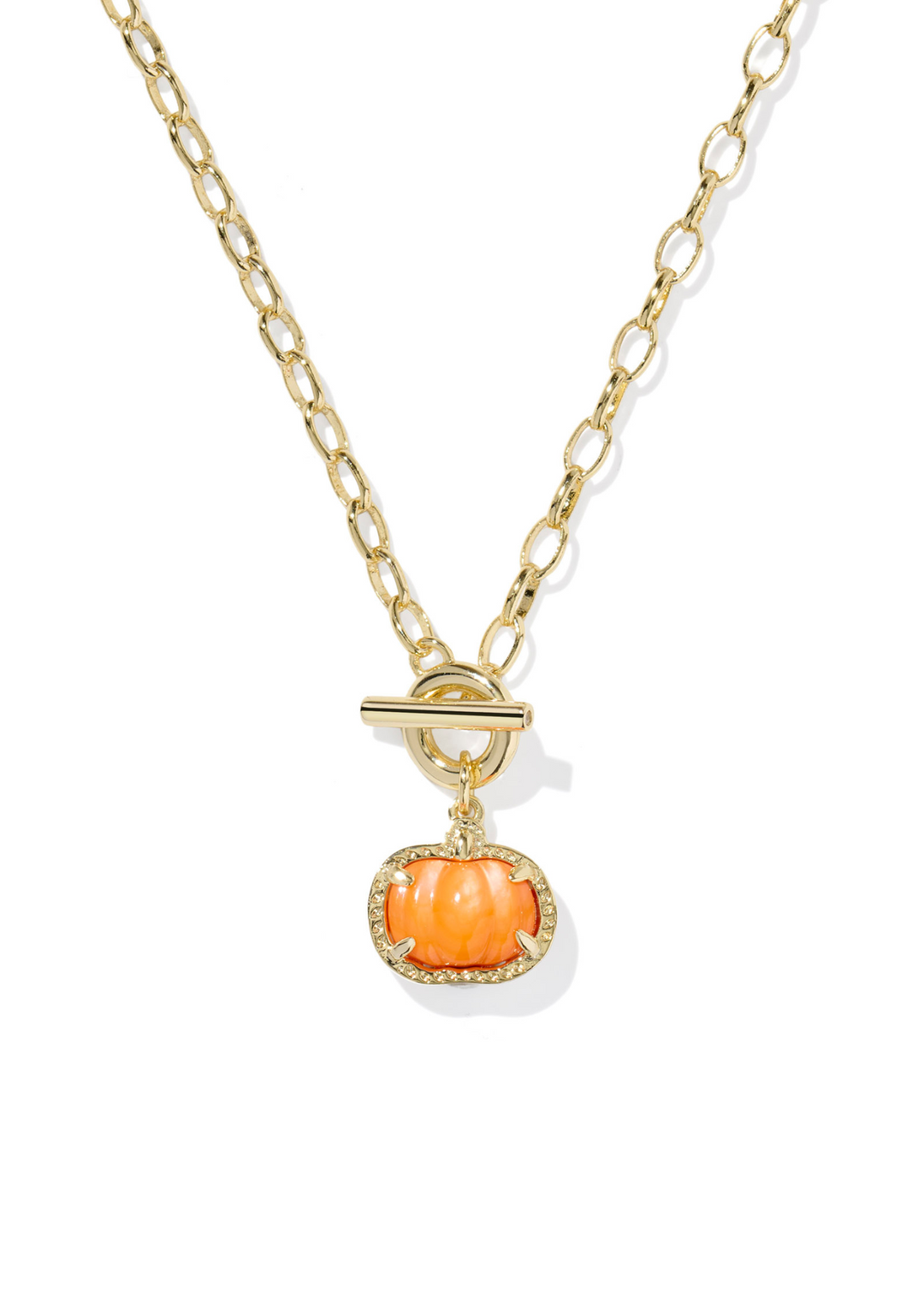 Gold link and chain necklace with an orange pumpkin pendant framed in gold on a white background