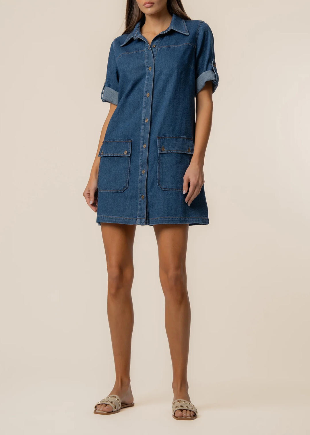 Woman wearing a collared denim mini dress with sandals