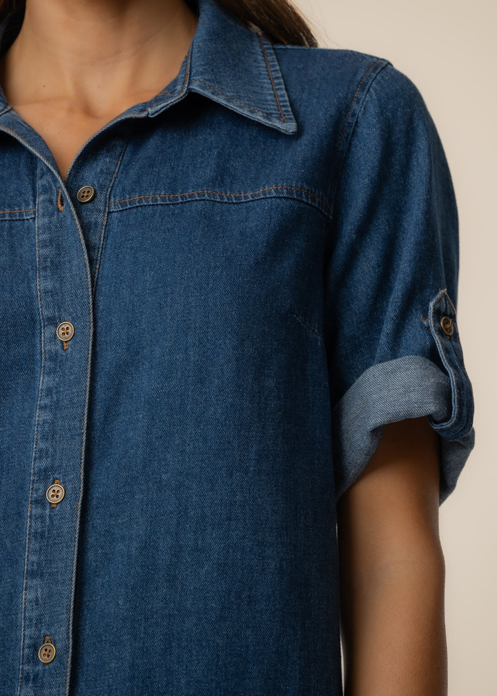 Close up of a woman wearing a collared denim mini dress