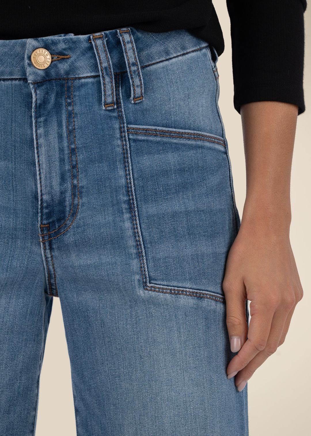Close up of a woman wearing medium wash blue jeans