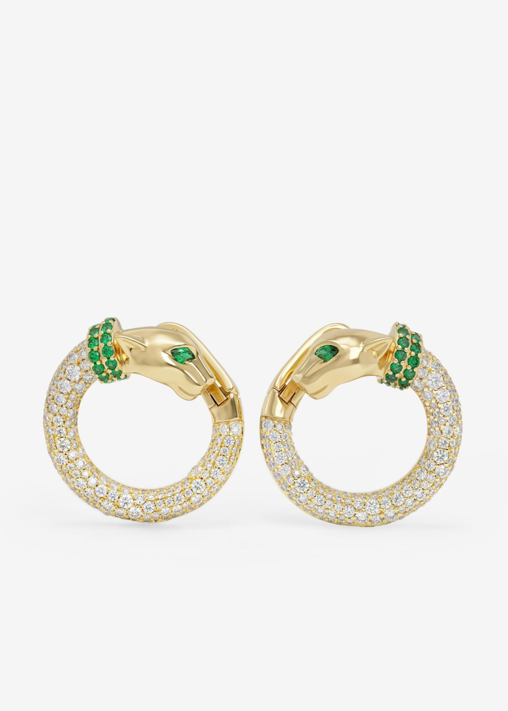 Gold pave hoops with simulated emeralds and a jaguar clasp on a white background