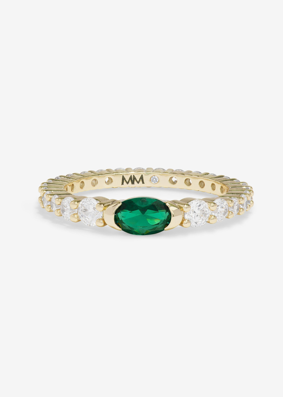Gold ring with simulated diamonds and an emerald stone on a white background